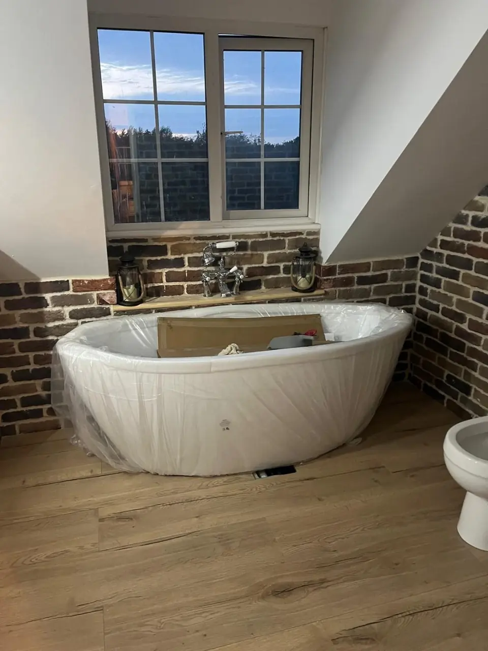Freestanding bath installed beneath the bathroom window