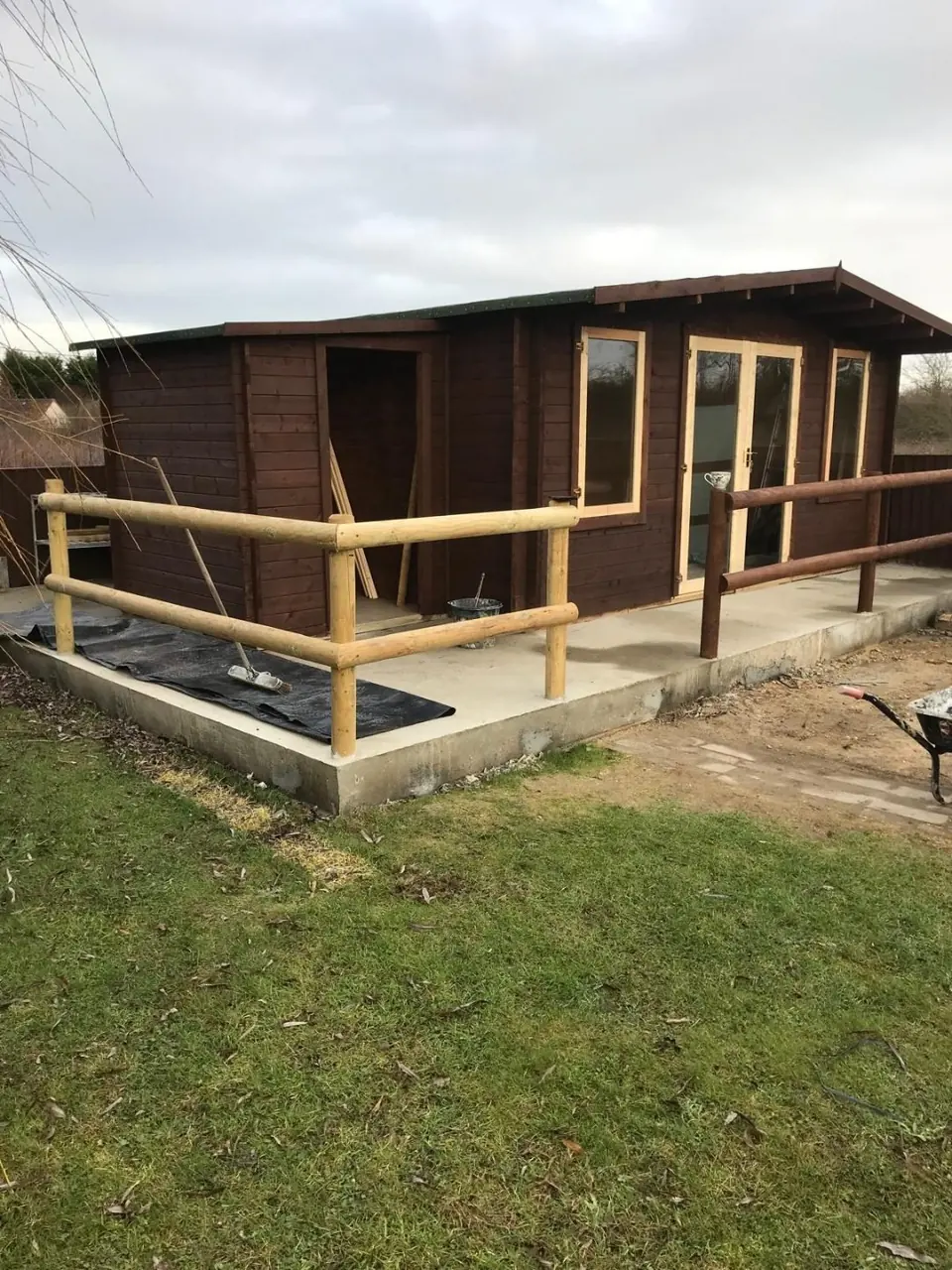 Early progress photograph showing the concrete base prepared for the cabin