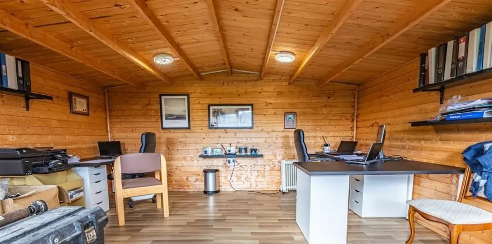 Finished-project photograph showing the completed timber-lined office interior