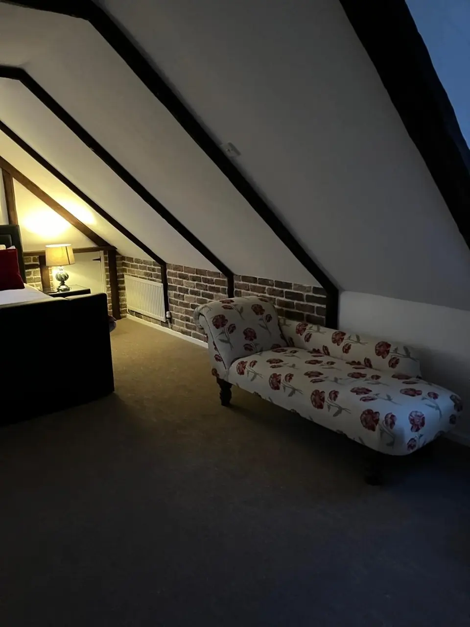 Finished-project photograph showing the converted roof space and exposed beams