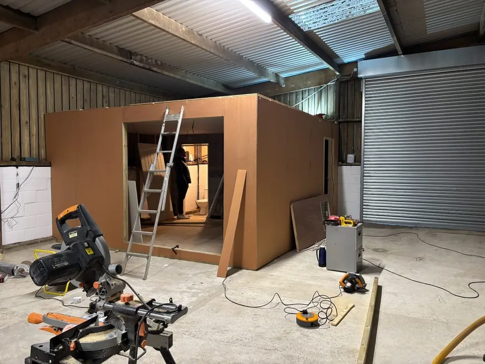 Office pod enclosed with external sheeting inside the workshop
