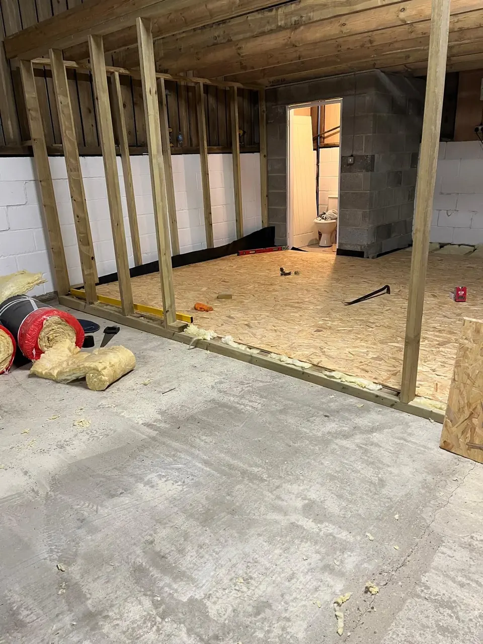 Office pod floor deck and timber wall framing around the existing blockwork room