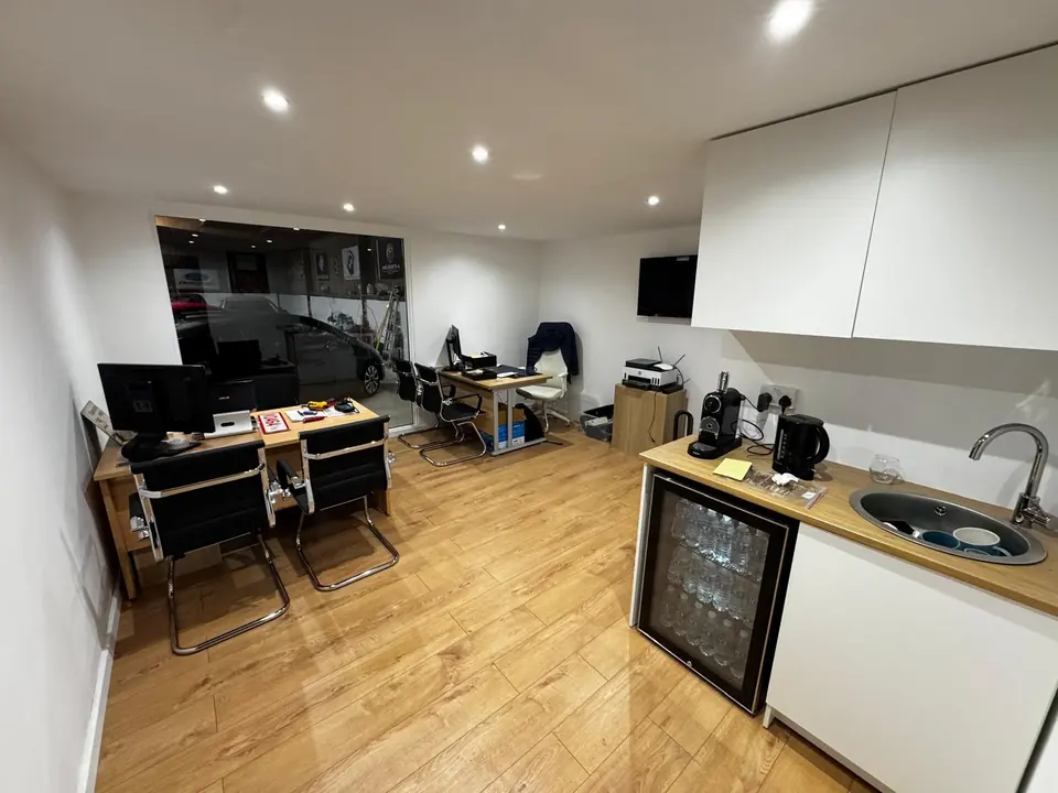 Furnished office pod with desks, fitted cupboards, sink and under-counter fridge
