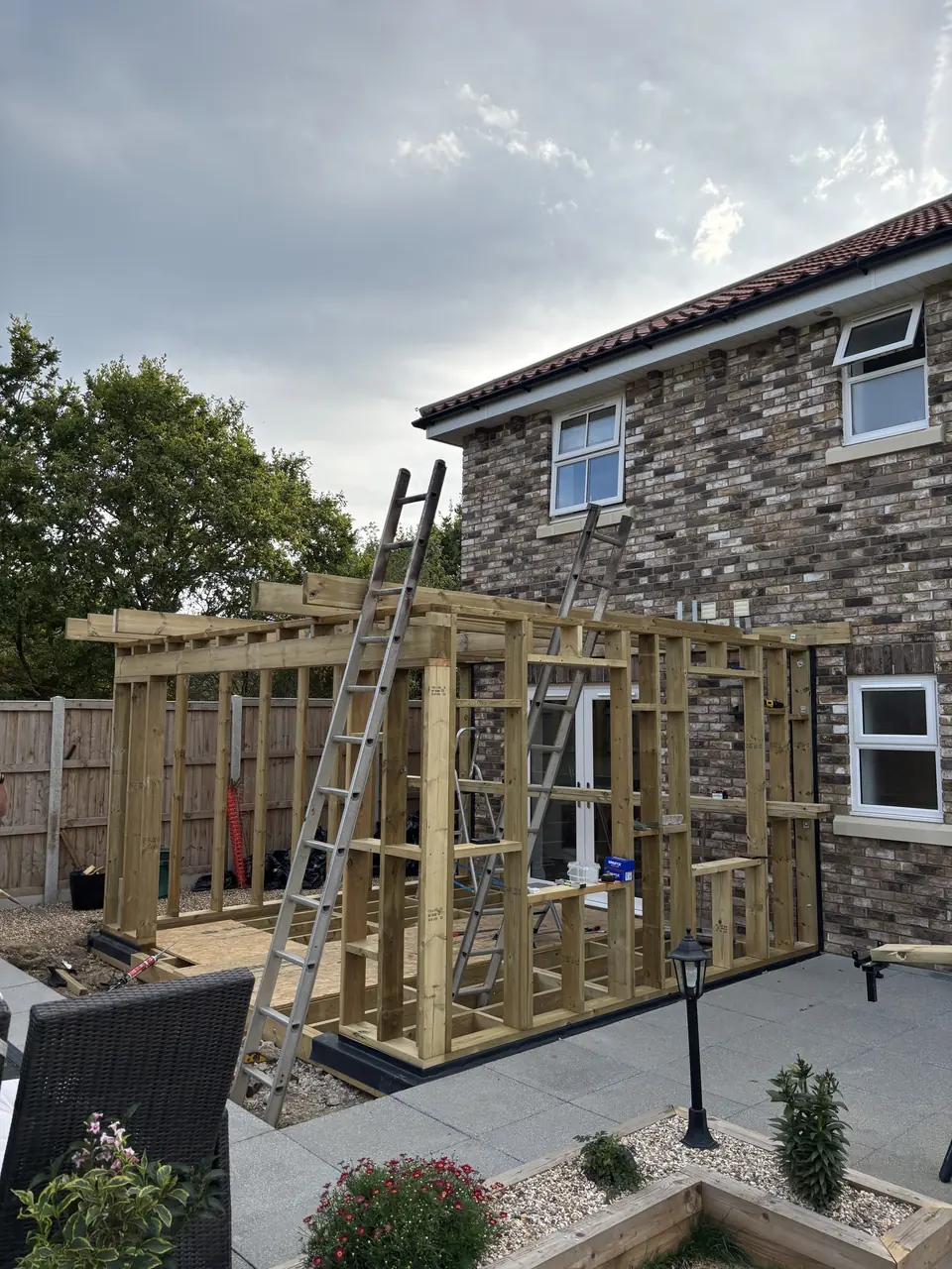 Timber frame and roof structure alongside the existing house