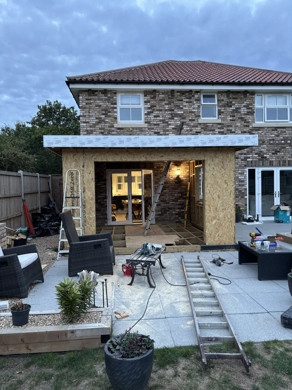 Timber extension in progress with sheathing, fascia and framed openings