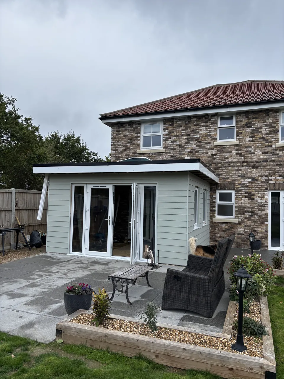 Clad timber extension seen from the garden beside the patio
