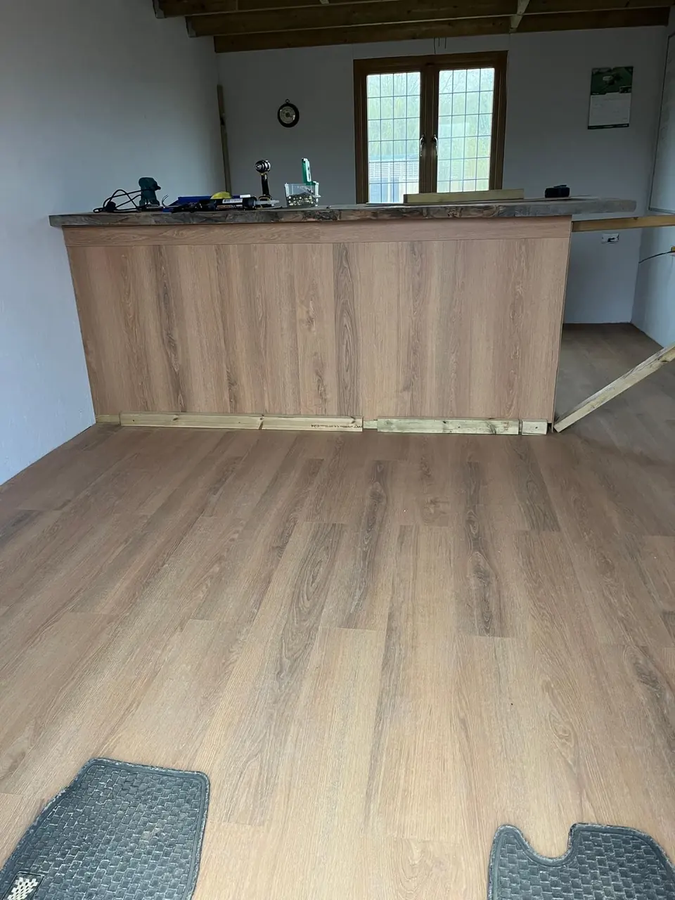 Interior with wood-effect flooring and a timber-fronted fitted counter