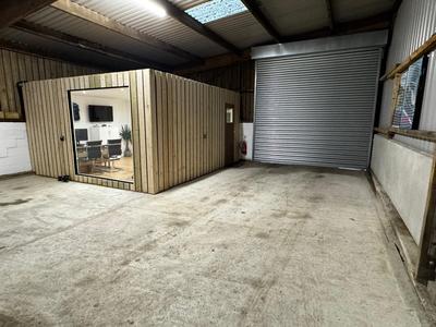 Completed timber-clad office pod with full glazing